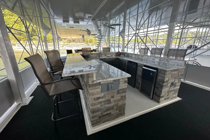 Slide: The Image of Luxurious 2022 Trifecta houseboat with modern outdoor bar and seating area. - 51