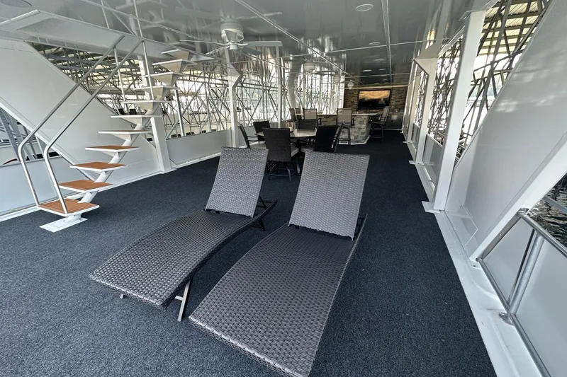 Slide: The Image of Luxurious 2022 Trifecta houseboat interior with lounge chairs and modern staircase. - 58