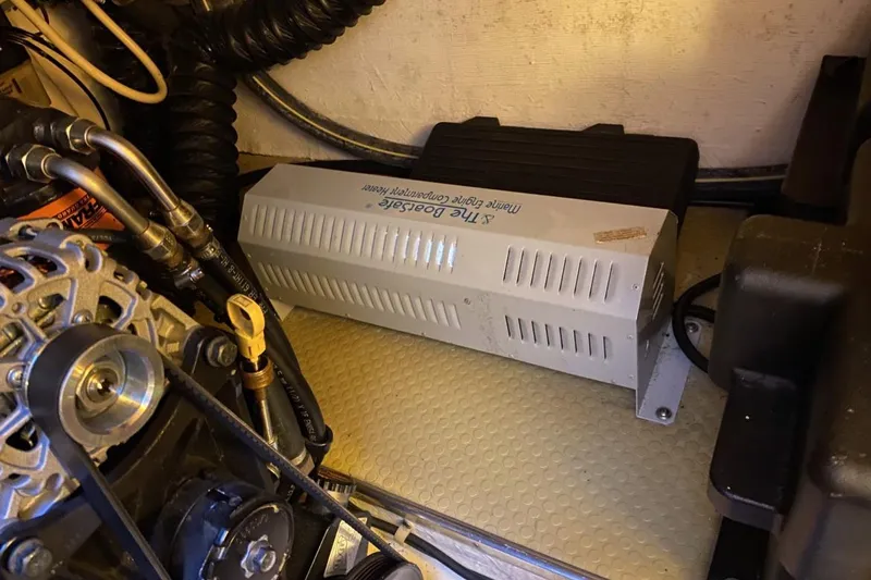 Slide: The Image of Engine compartment of a 2004 Larson Cabrio 330 boat with marine engine components. - 11