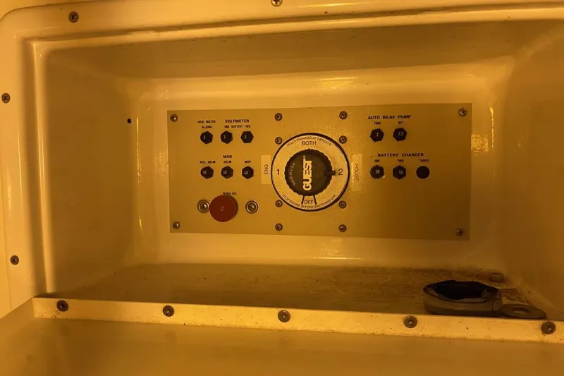 Slide: The Image of Control panel of a 2004 Larson Cabrio 330 boat, featuring various switches and dials. - 16