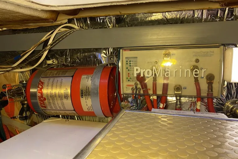 Slide: The Image of Engine room of 2004 Larson Cabrio 330 with ProMariner charger and fire extinguisher system. - 20