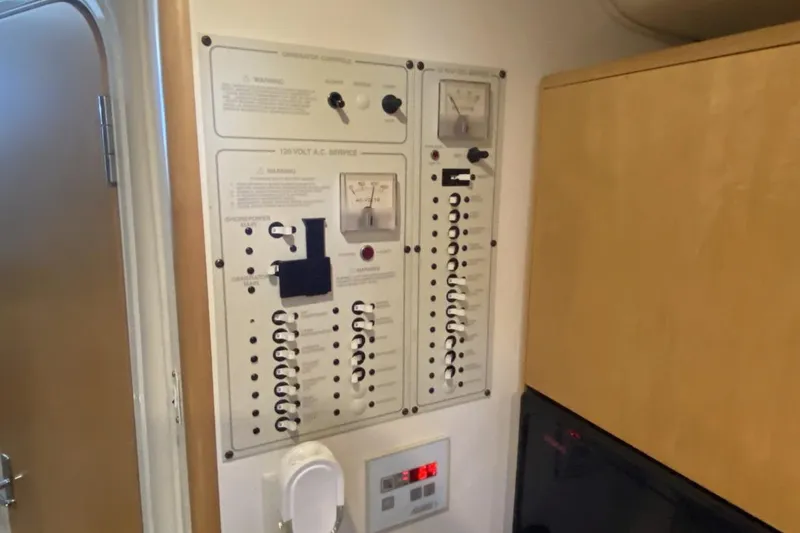 Slide: The Image of Electrical control panel inside a 2004 Larson Cabrio 330 boat cabin. - 25