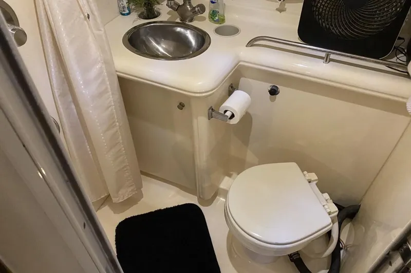 Slide: The Image of Bathroom interior of 2004 Larson Cabrio 330 boat with sink and toilet. - 26