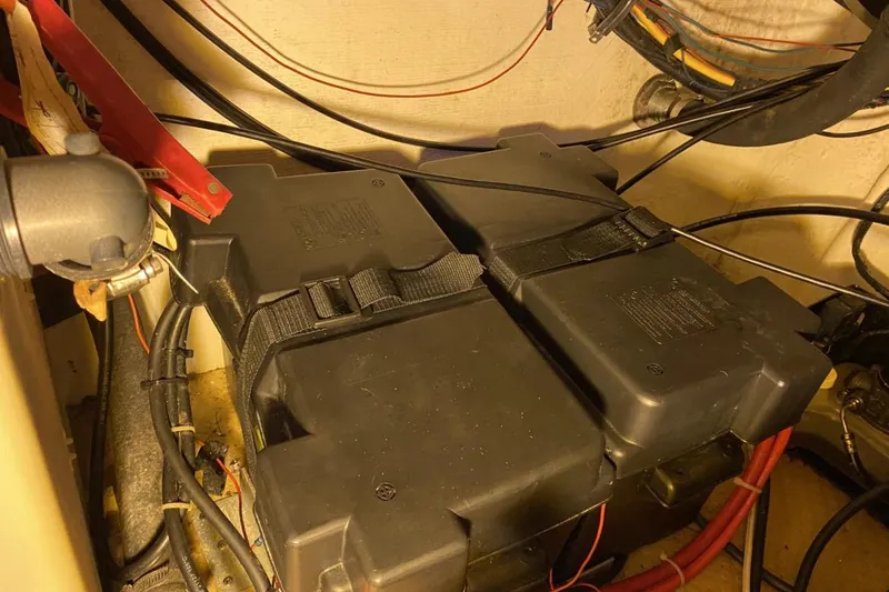 Slide: The Image of Battery compartment of a 2004 Larson Cabrio 330 boat, featuring secured wiring and connections. - 28