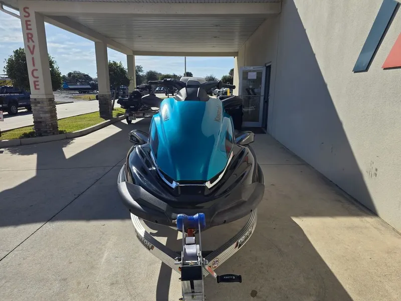 Slide: The Image of 2022 Kawasaki STX®160LX jet ski in a service area. - 2