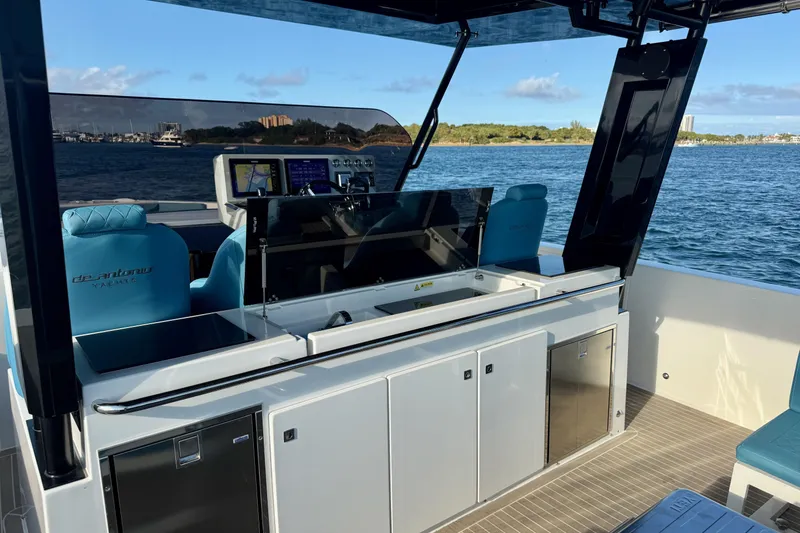 Slide: The Image of 2022 De Antonio Yachts 42 interior with modern helm and seating on open water. - 14