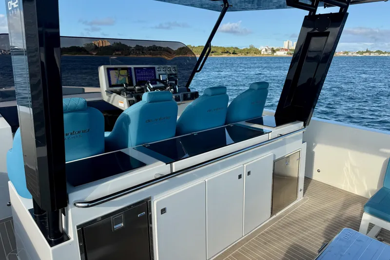 Slide: The Image of Modern 2022 De Antonio Yachts 42 with sleek cockpit and blue seating on open water. - 15