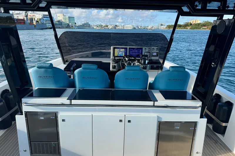 Slide: The Image of De Antonio Yachts 42, 2022 model, luxury yacht interior with blue seating and navigation controls. - 16