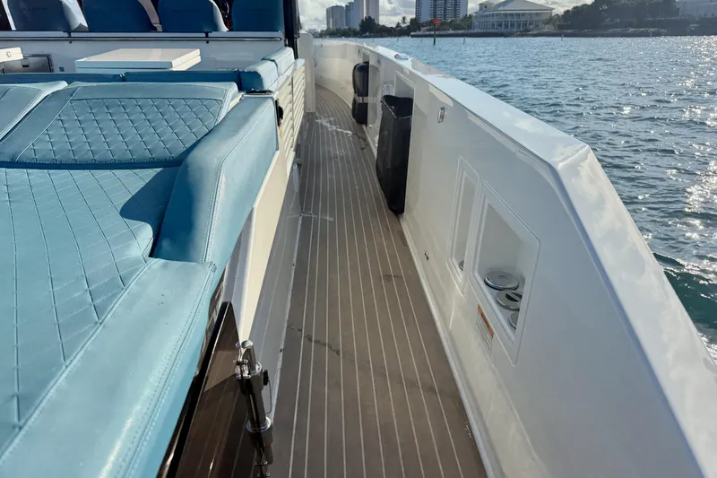Slide: The Image of 2022 De Antonio Yachts 42 with blue seating, docked by the water. - 21