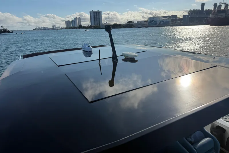 Slide: The Image of 2022 De Antonio Yachts 42 on water, reflecting sky and cityscape in the background. - 28