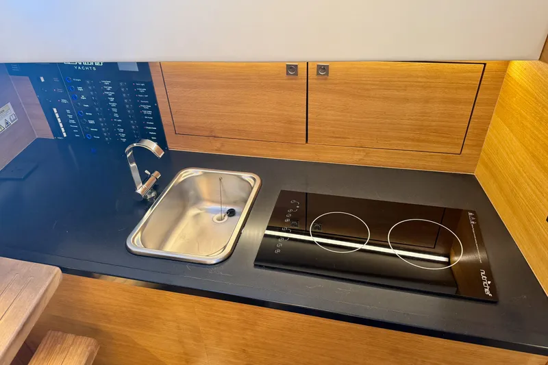 Slide: The Image of Modern kitchen in 2022 De Antonio Yachts 42, featuring sleek sink and induction cooktop. - 32