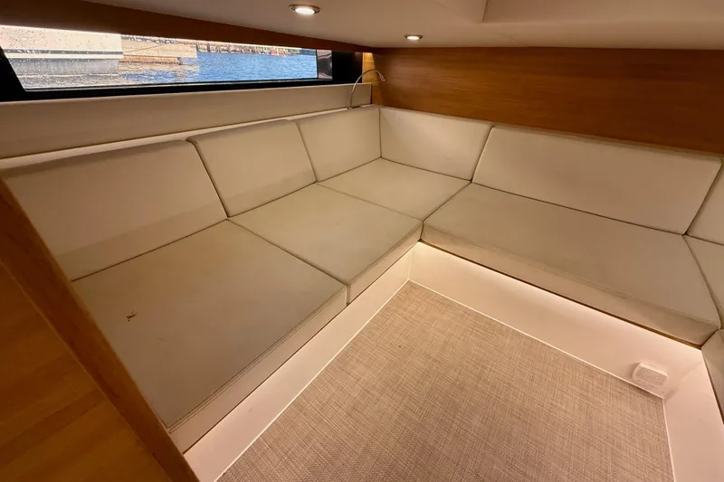 Slide: The Image of Luxurious interior seating of 2022 De Antonio Yachts 42, featuring elegant cushions and wood accents. - 37