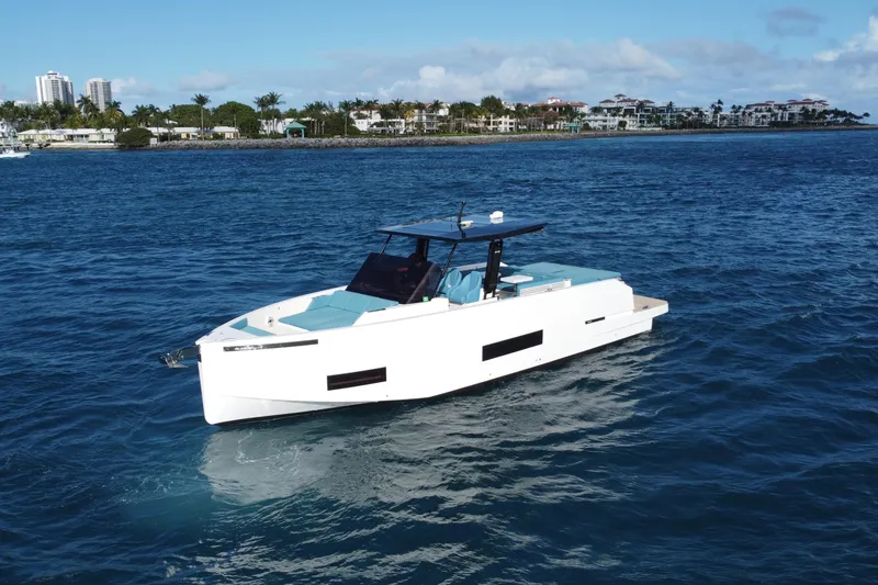 Slide: The Image of 2022 De Antonio Yachts 42 cruising on blue ocean near coastal cityscape. - 4