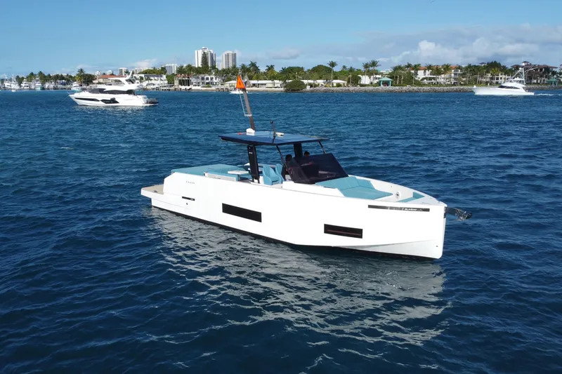 Slide: The Image of 2022 De Antonio Yachts 42 cruising on blue waters near a coastal city. - 41