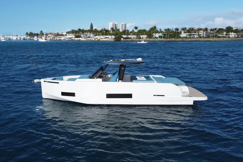 Slide: The Image of 2022 De Antonio Yachts 42 on open water, sleek design, coastal background. - 43