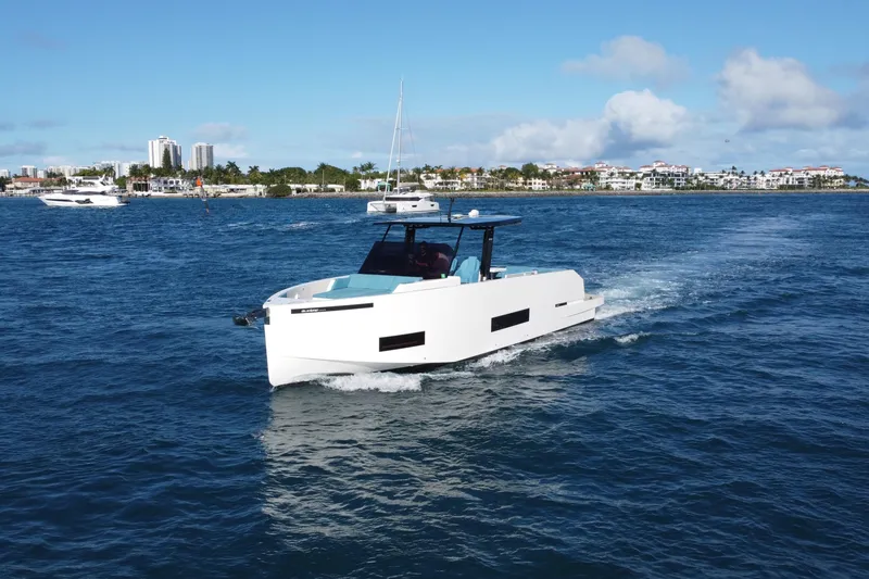 Slide: The Image of 2022 De Antonio Yachts 42 cruising on blue ocean near coastal cityscape. - 48