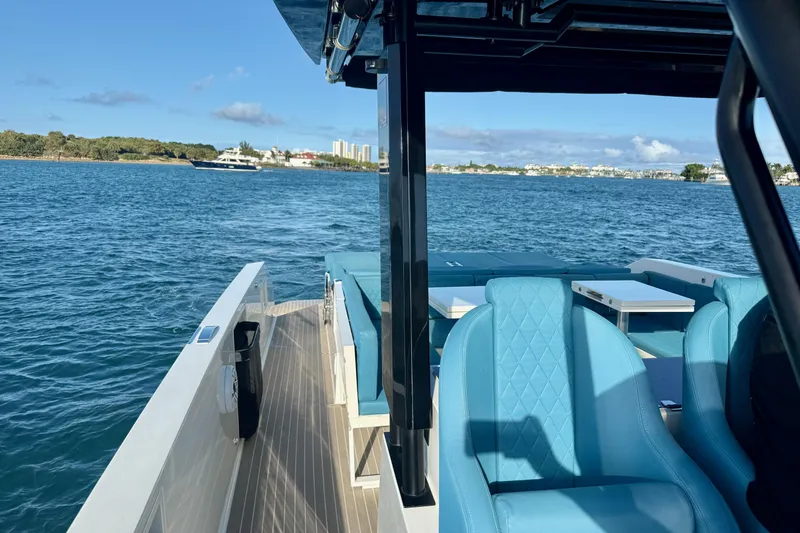 Slide: The Image of De Antonio Yachts 42, 2022 model, cruising on a sunny day with blue seating. - 51