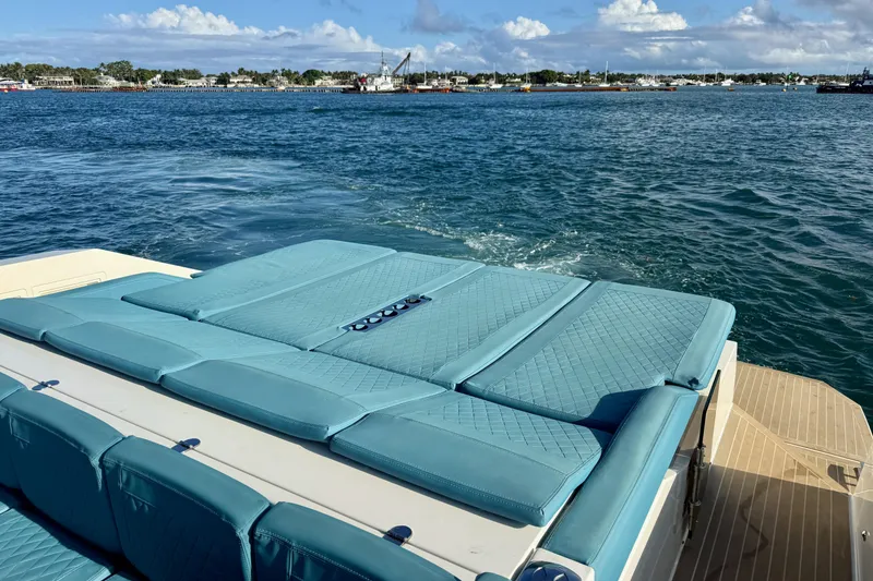 Slide: The Image of 2022 De Antonio Yachts 42 with teal seating, cruising on a sunny day. - 53