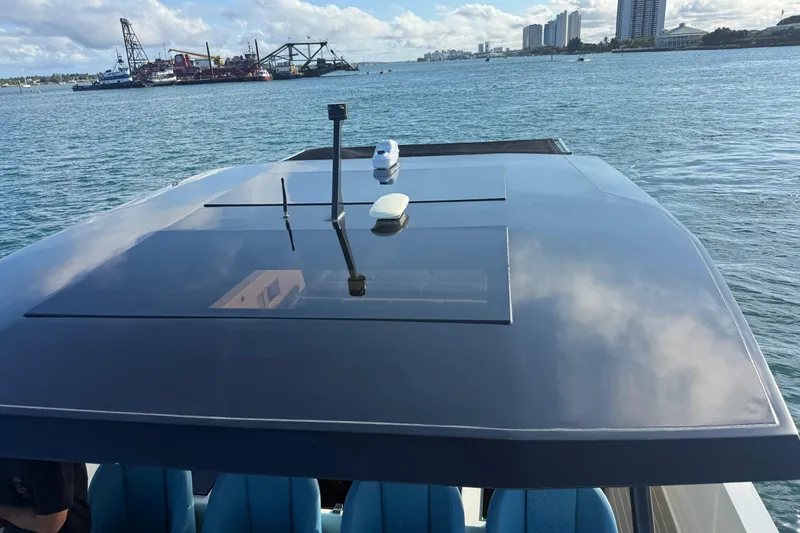 Slide: The Image of 2022 De Antonio Yachts 42 on water, sleek design with city skyline in background. - 58