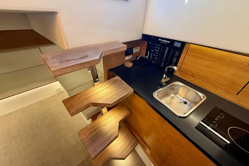 Slide: The Image of Modern interior of 2022 De Antonio Yachts 42, featuring wooden steps and compact kitchenette. - 67