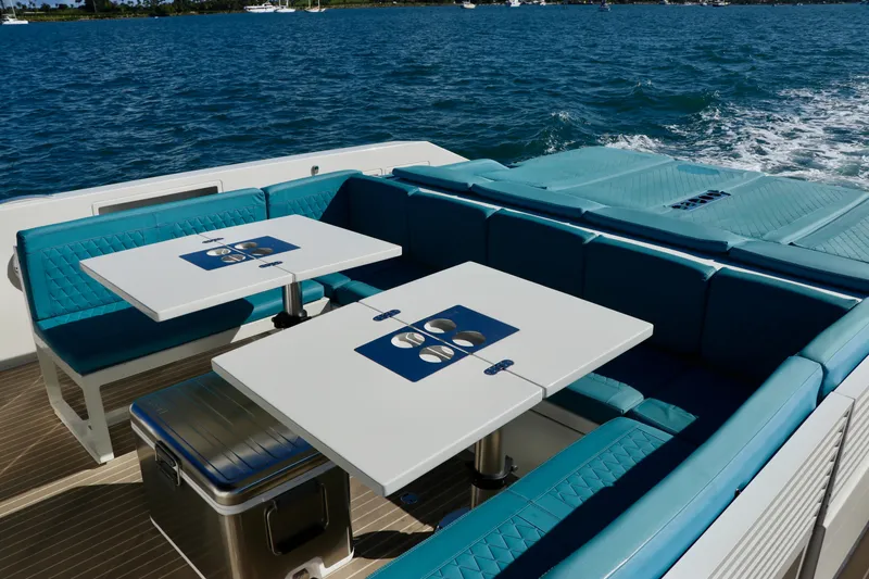 Slide: The Image of Luxury seating area on 2022 De Antonio Yachts 42, featuring elegant tables and ocean view. - 77