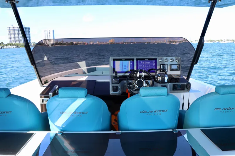 Slide: The Image of Cockpit view of 2022 De Antonio Yachts 42, featuring modern controls and blue seating. - 78