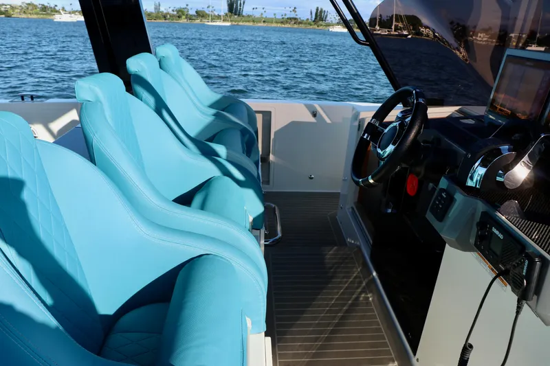 Slide: The Image of Interior of 2022 De Antonio Yachts 42 with blue seats and modern controls. - 79
