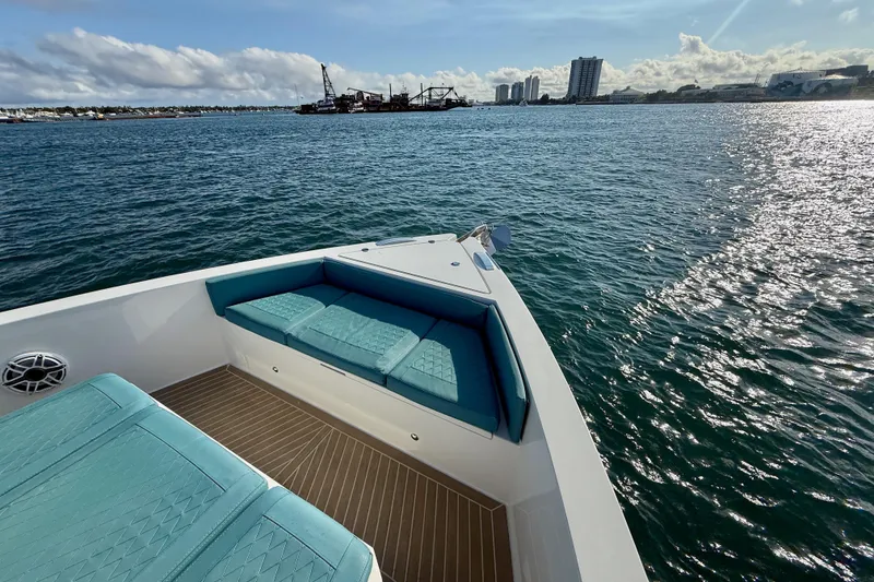 Slide: The Image of De Antonio Yachts 42, 2022 model, cruising on a sunny day with city skyline. - 9