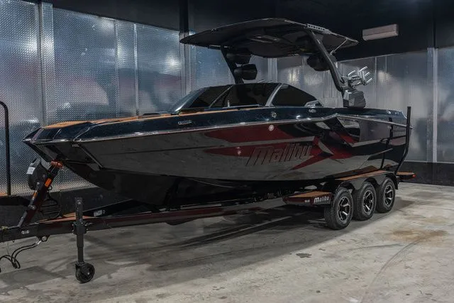 Slide: The Image of 2026 Malibu Wakesetter 24 MXZ boat in a garage. - 24