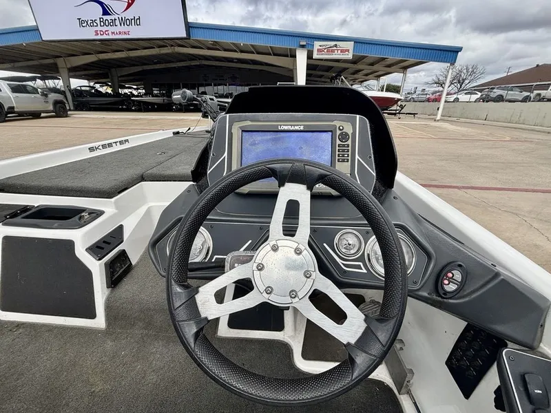 Slide: The Image of Interior view of a 2016 Skeeter ZX225 boat with steering wheel and electronics. - 5