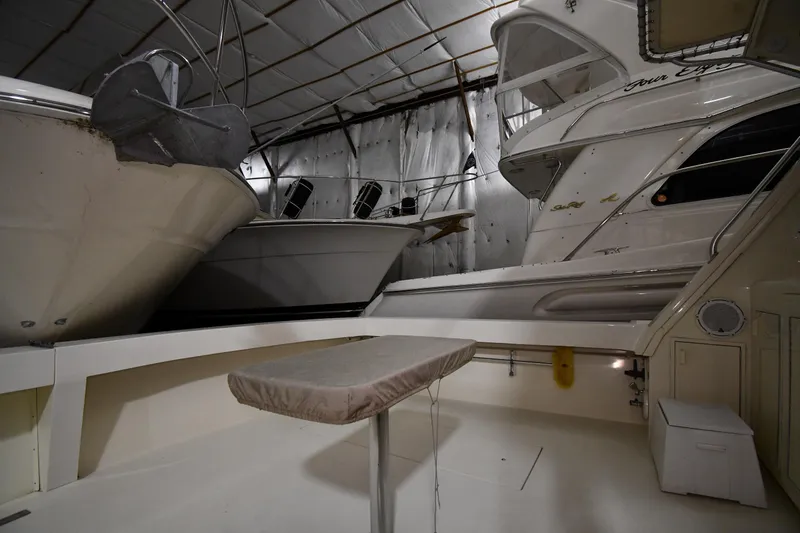Slide: The Image of 1988 Viking 48 Convertible yacht in indoor storage, showcasing sleek design and spacious deck. - 10