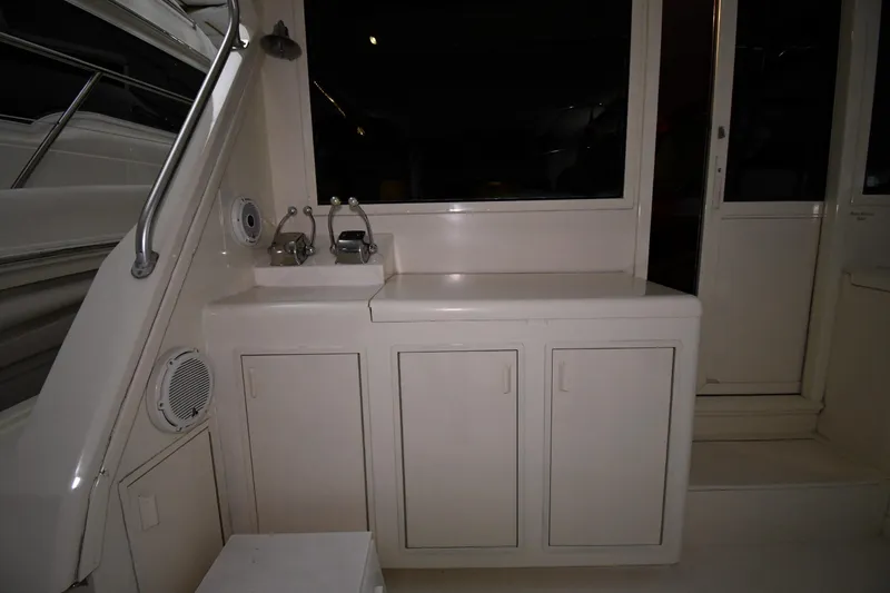 Slide: The Image of 1988 Viking 48 Convertible yacht interior with cabinets and sink area. - 11