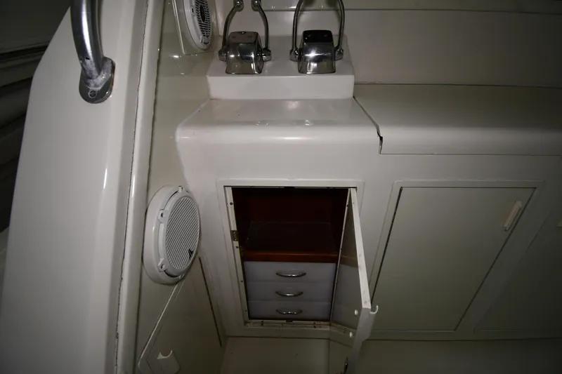 Slide: The Image of Interior of 1988 Viking 48 Convertible yacht showing storage cabinet and control panel. - 14