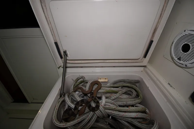 Slide: The Image of Storage compartment with coiled ropes on a 1988 Viking 48 Convertible boat. - 16