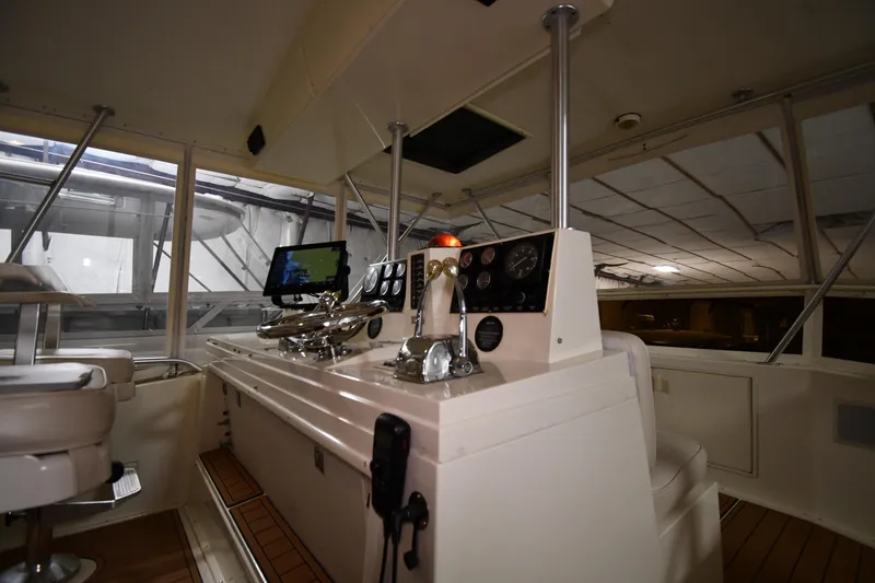 Slide: The Image of 1988 Viking 48 Convertible yacht interior with navigation controls and seating. - 20