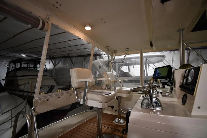 Slide: The Image of Interior view of 1988 Viking 48 Convertible yacht helm with controls and seating. - 21