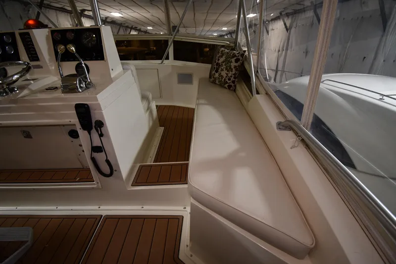 Slide: The Image of 1988 Viking 48 Convertible yacht interior with helm and cushioned seating. - 22