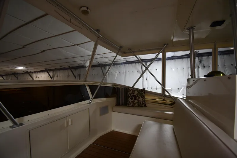 Slide: The Image of Interior view of a 1988 Viking 48 Convertible yacht with seating and windows. - 23
