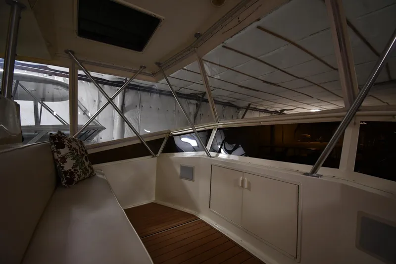 Slide: The Image of Interior of 1988 Viking 48 Convertible yacht with seating and wooden flooring. - 24