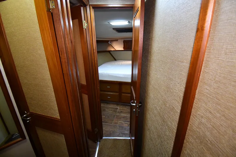 Slide: The Image of Interior cabin of 1988 Viking 48 Convertible yacht with wooden doors and cozy bed. - 31