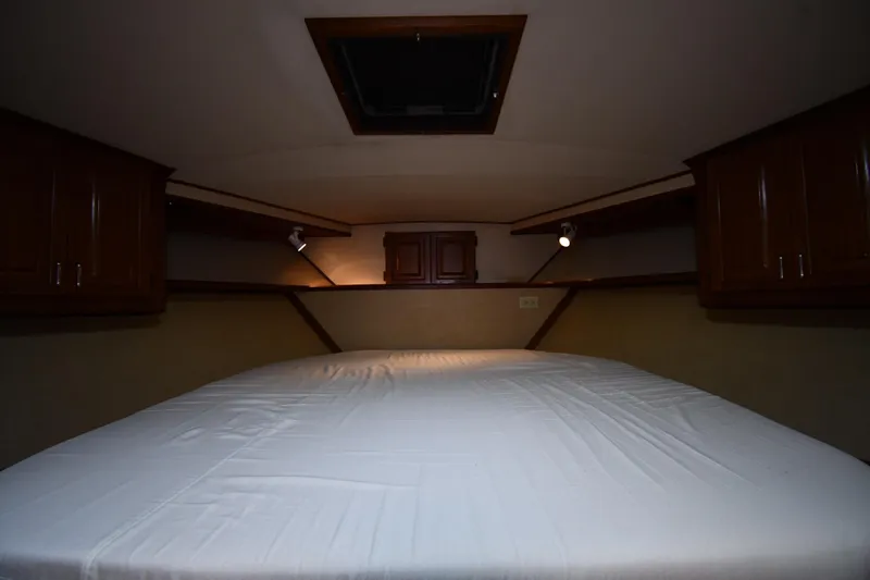 Slide: The Image of Interior cabin of 1988 Viking 48 Convertible yacht with bed and wooden cabinets. - 32