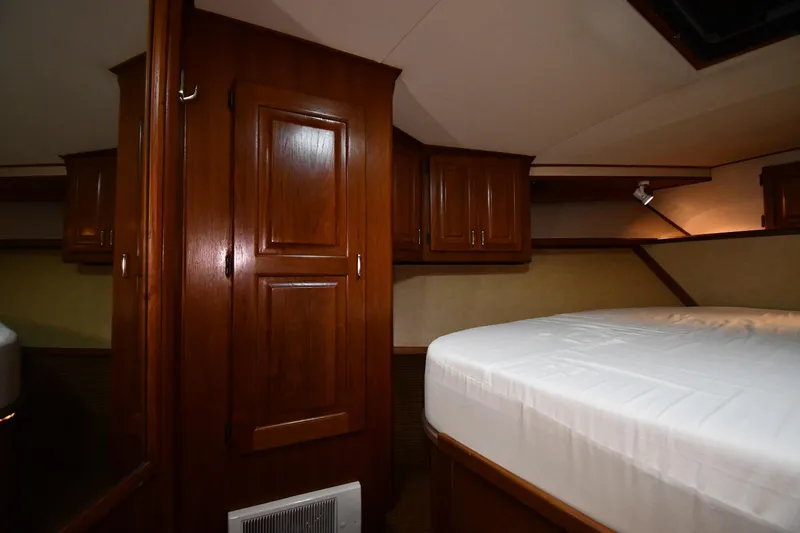 Slide: The Image of Interior cabin of 1988 Viking 48 Convertible yacht with wooden cabinetry and bed. - 34