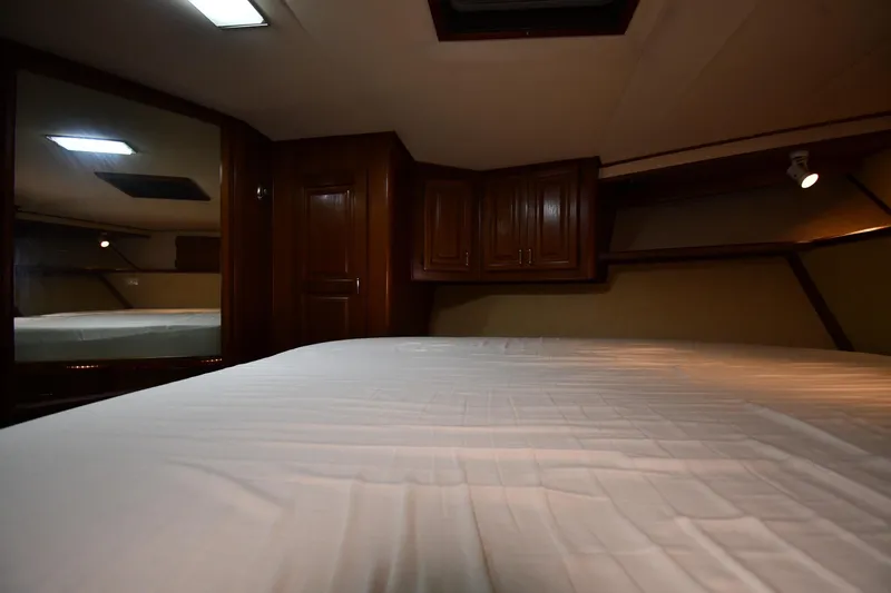 Slide: The Image of Interior cabin of 1988 Viking 48 Convertible yacht with wooden cabinets and bed. - 35
