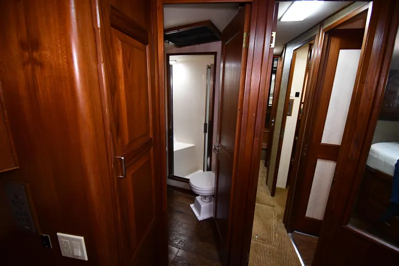 Slide: The Image of 1988 Viking 48 Convertible yacht interior with wooden finish and compact bathroom. - 37