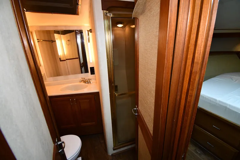 Slide: The Image of 1988 Viking 48 Convertible yacht bathroom with wooden cabinetry and shower. - 40