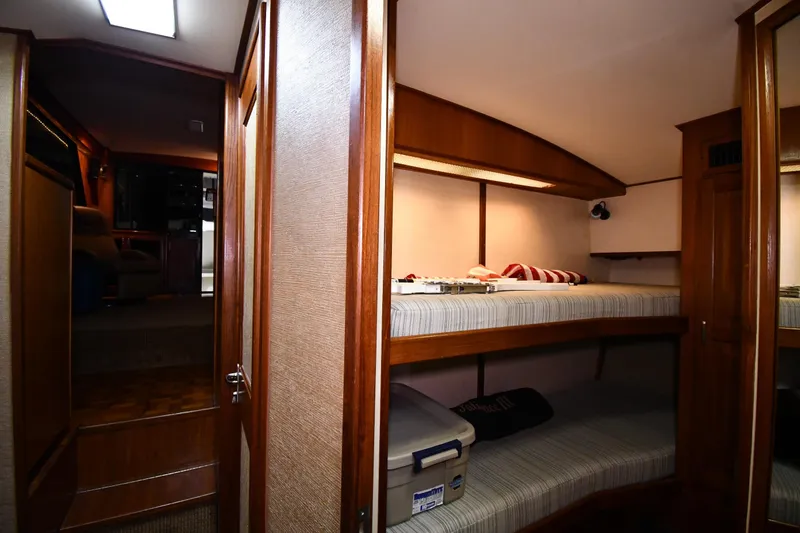Slide: The Image of 1988 Viking 48 Convertible yacht interior with cozy bunk beds and wooden finishes. - 43