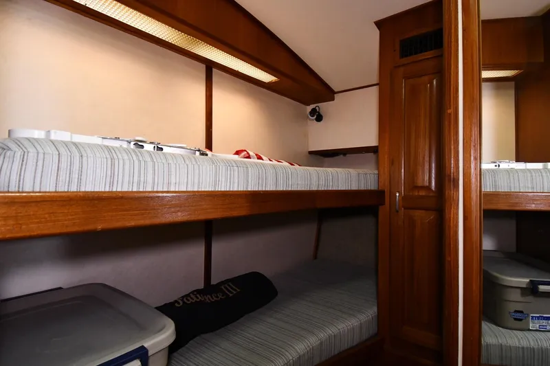 Slide: The Image of 1988 Viking 48 Convertible yacht interior with wooden bunk beds and storage. - 44
