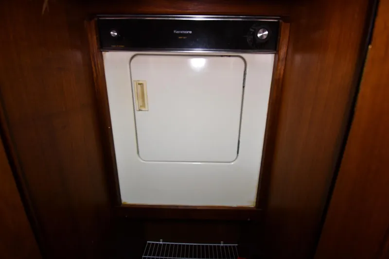 Slide: The Image of Kenmore dryer inside 1988 Viking 48 Convertible yacht, wooden paneling. - 48