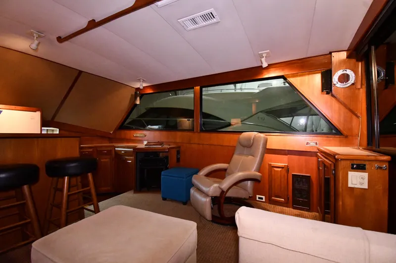 Slide: The Image of Interior of 1988 Viking 48 Convertible yacht with wood paneling and comfortable seating. - 49