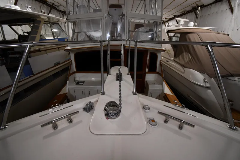 Slide: The Image of 1988 Viking 48 Convertible yacht in storage, showcasing deck and railing details. - 5